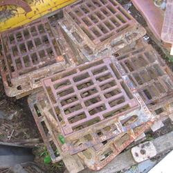 VARIOUS CAST IRON MANHOLES & GRIDS .